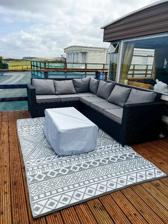 a couch sitting on top of a deck at Caravan Nr 51 Only for Family Holiday