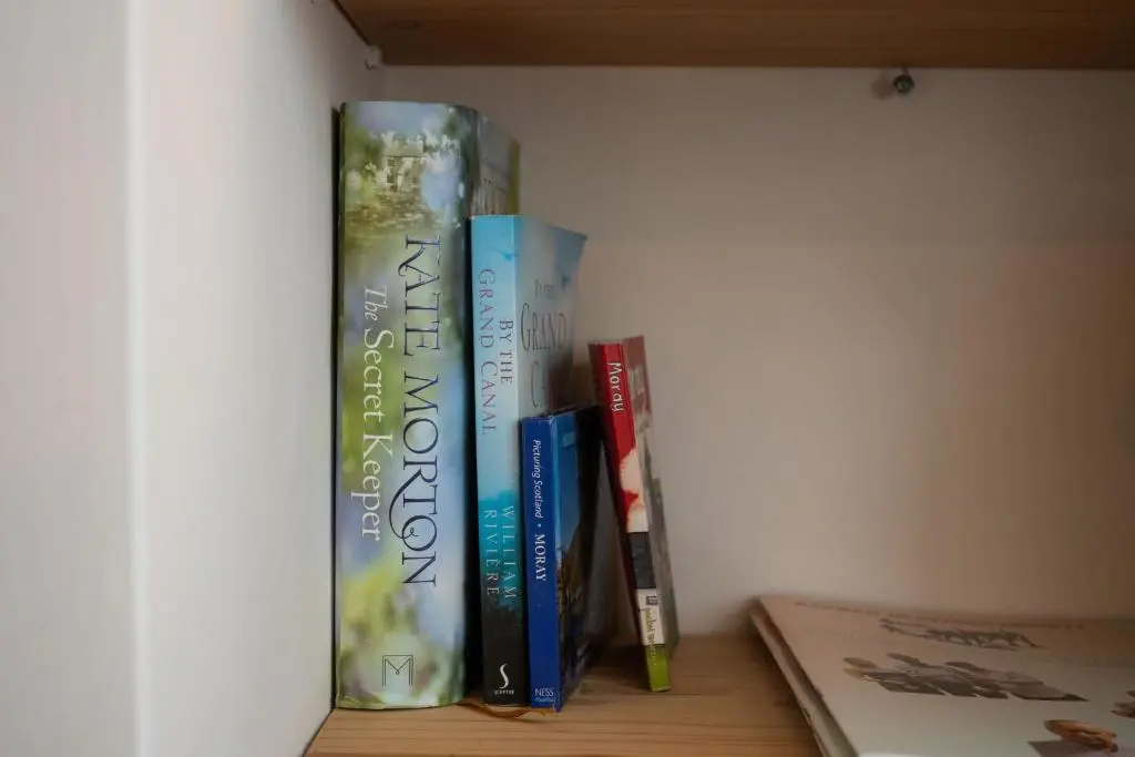 three books are sitting on a shelf at Seabreeze Cottage, 17 Seatown, Gardenstown in Gardenstown