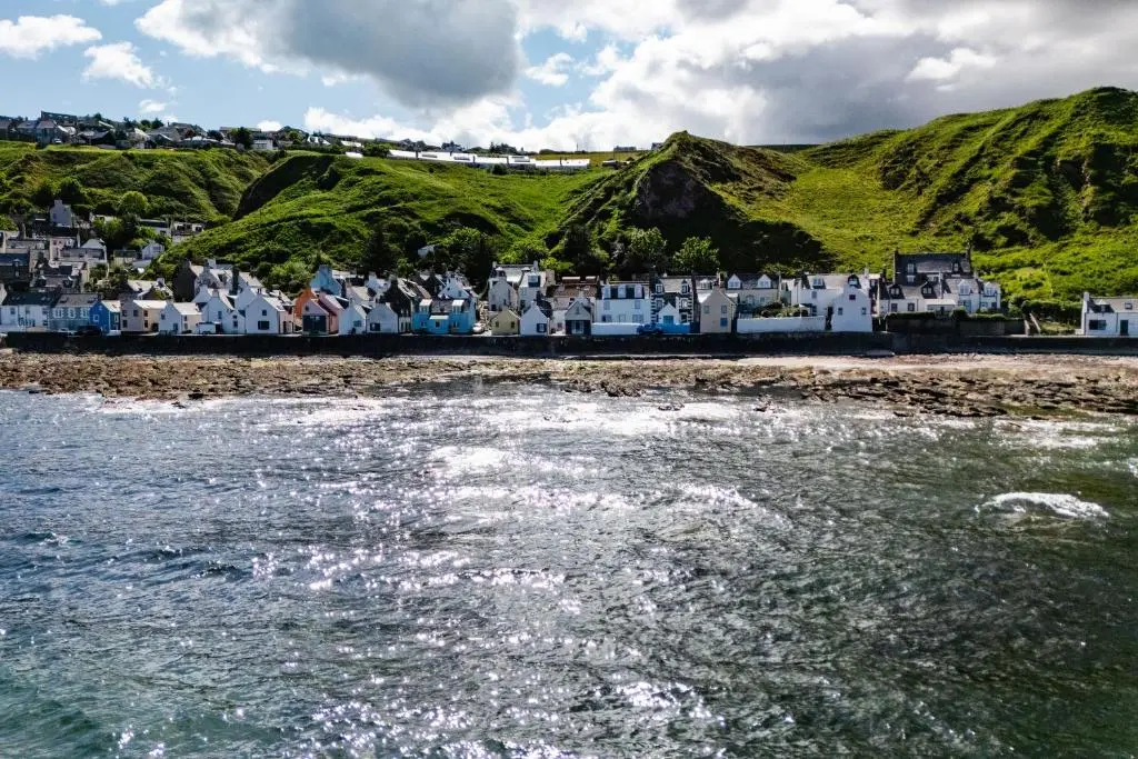 a group of houses on the shore of a beach at Nautical Nook, 16 Seatown, Gardenstown in Gardenstown