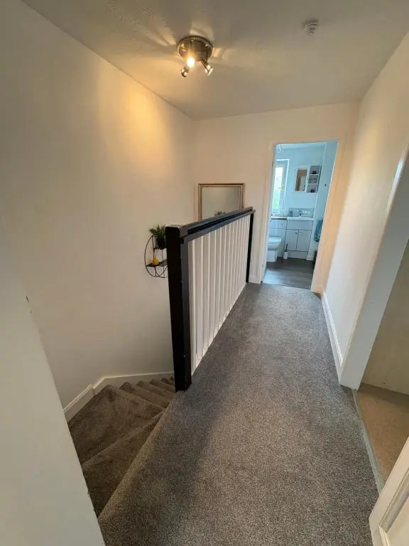 a hallway of a home with a stair railing at Apartment in Inverness in Inshes