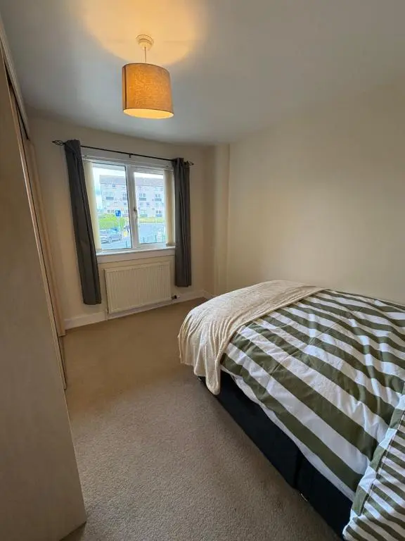 a bedroom with a bed and a window at Apartment in Inverness in Inshes