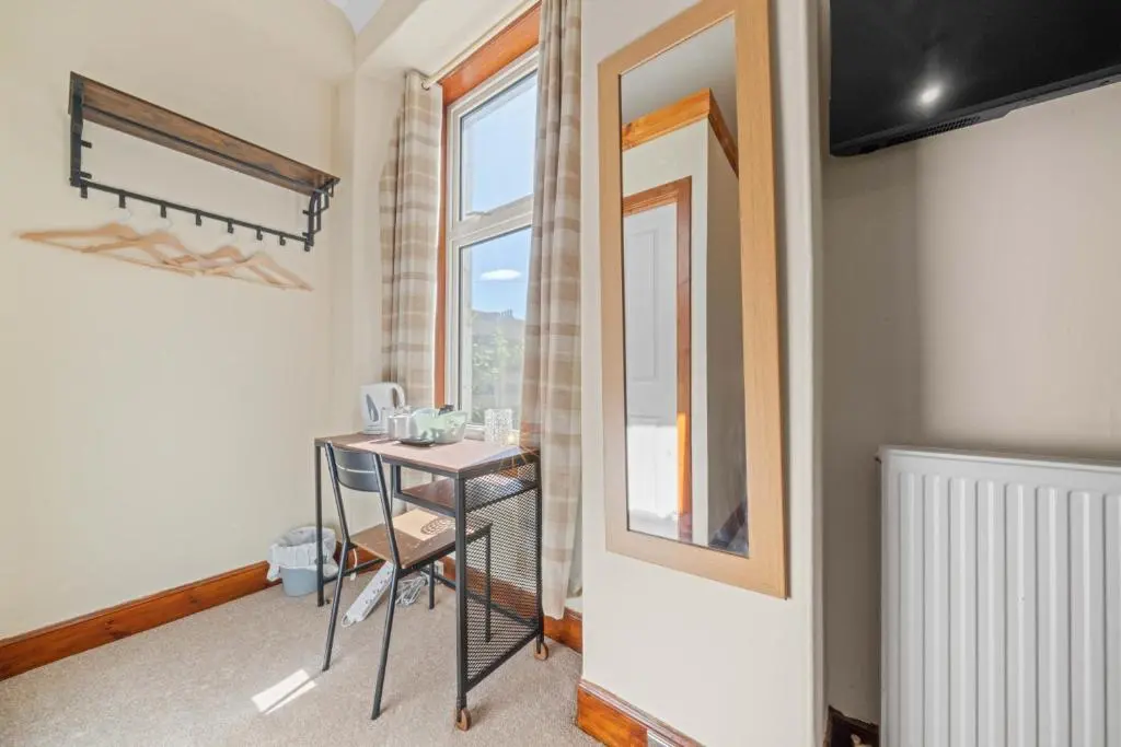 a room with a table and a window at mySTAYINN Cedar Villa Guest House in Inverness