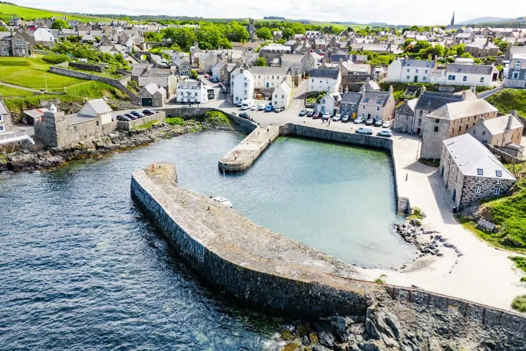 an aerial view of a town next to a body of water at Hideaway Cottage W Hot Tub in Portsoy