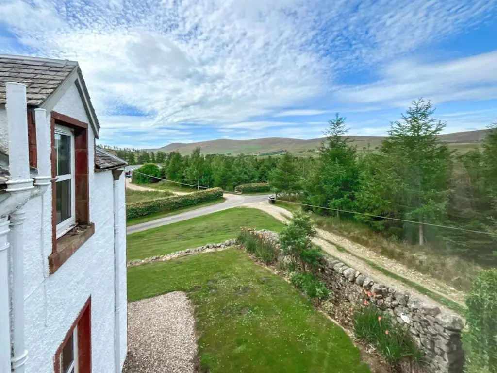 arial view of a house and a road at Rottal Farmhouse in Millton of Clova