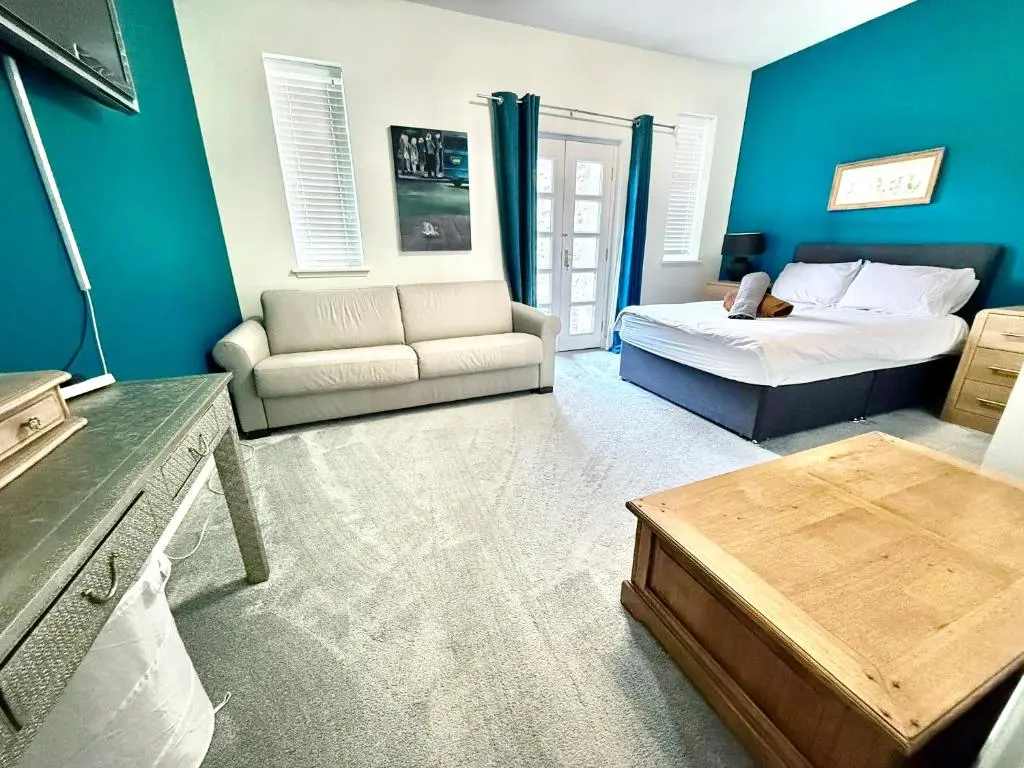a living room with a bed and a couch at Spacious Iconic Lesmurdie House 2 bed, free WiFi and Parking in Elgin