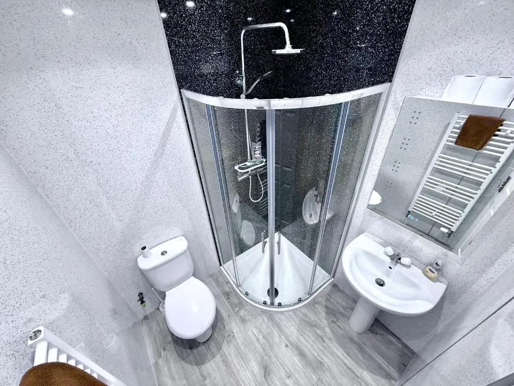 a bathroom with a shower and a toilet and a sink at Spacious Iconic Lesmurdie House 2 bed, free WiFi and Parking in Elgin