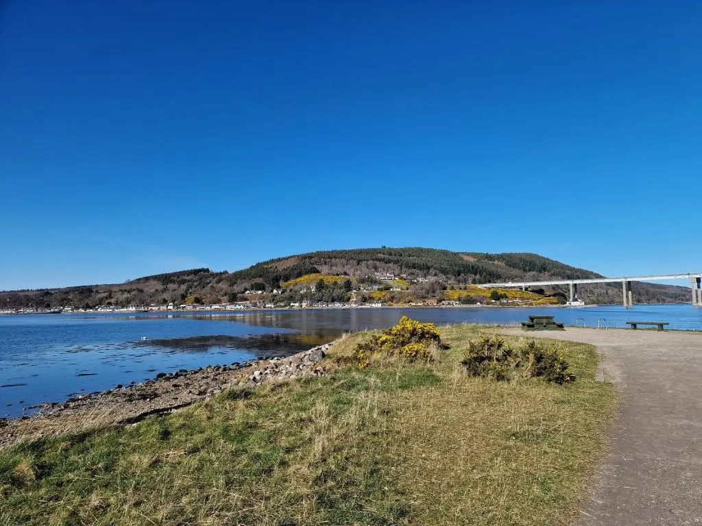 a view of a river with a bridge in the background at Failte Stay in Inverness