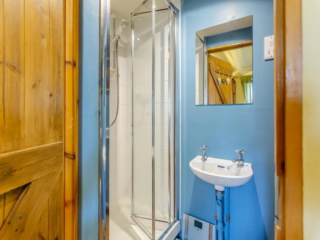 a bathroom with a sink and a shower at Little Tarbet in Dornoch