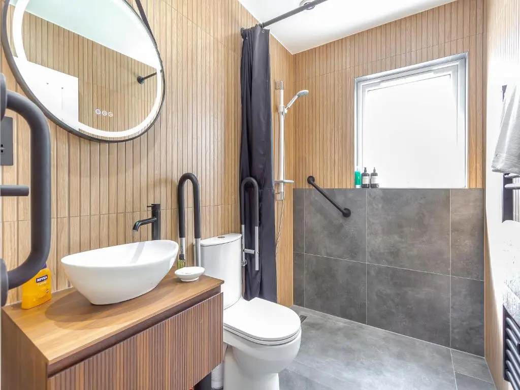 a bathroom with a toilet and a sink and a mirror at Highland Sanctuary in Dornoch