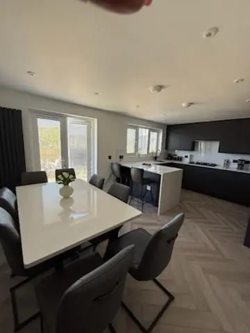 a dining room with a white table and chairs at Newly renovated house Elgin in Elgin