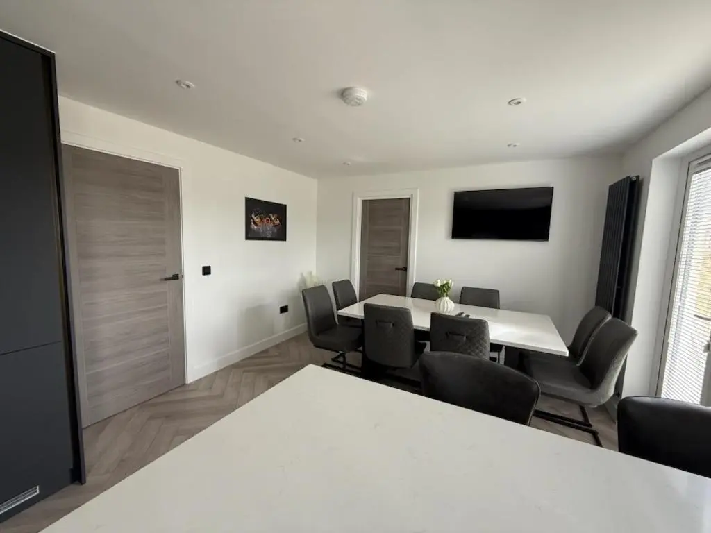 a dining room with a white table and chairs at Newly renovated house Elgin in Elgin