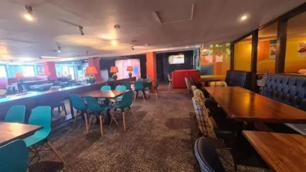 a restaurant with tables and chairs and a bar at A13 - Beach Haven at Silversands in Lossiemouth