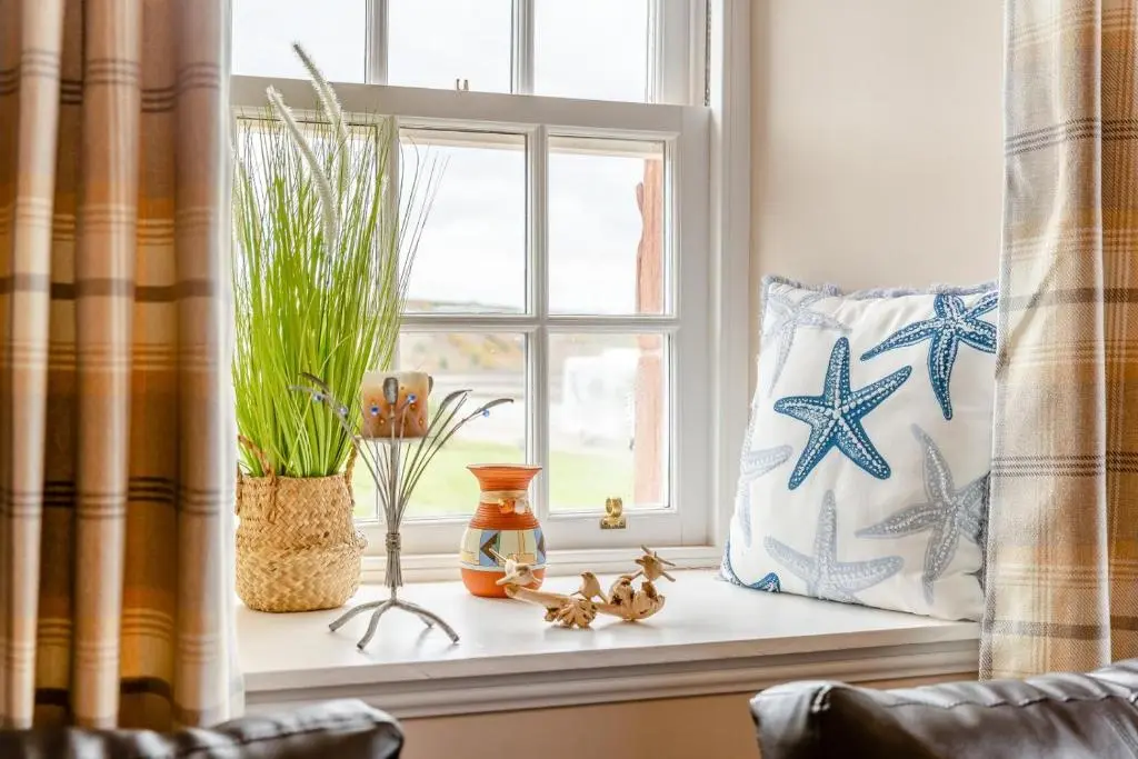 a window sill with some plants and a pillow at 2 Bed in Cromarty oc-s32047 in Cromarty