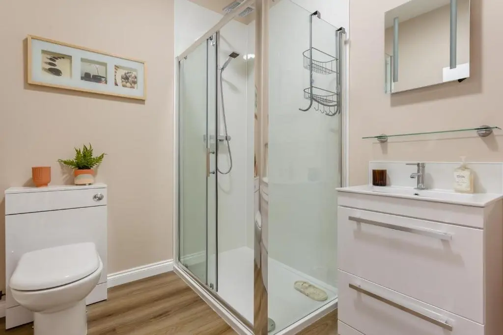 a bathroom with a shower and a toilet and a sink at 2 Bed in Cromarty oc-s32047 in Cromarty
