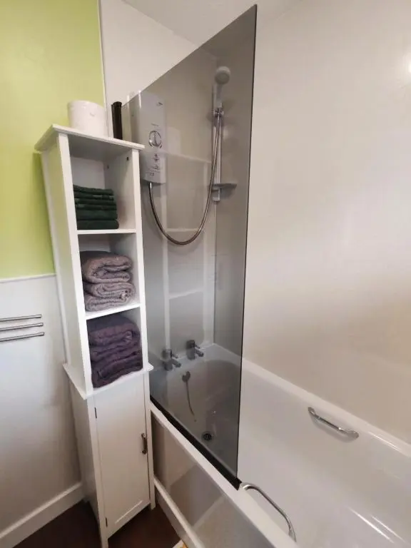 a bathroom with a shower with a glass door at Private Holiday Home in Inverness with Free Parking l Sleeps 4 in Dalneigh