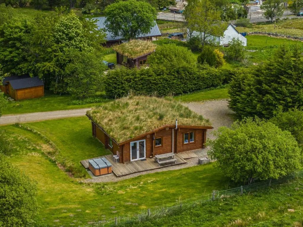 an overhead view of a house with a grass roof at Finest Retreats - Cragdhu Log Cabin in Glenshee