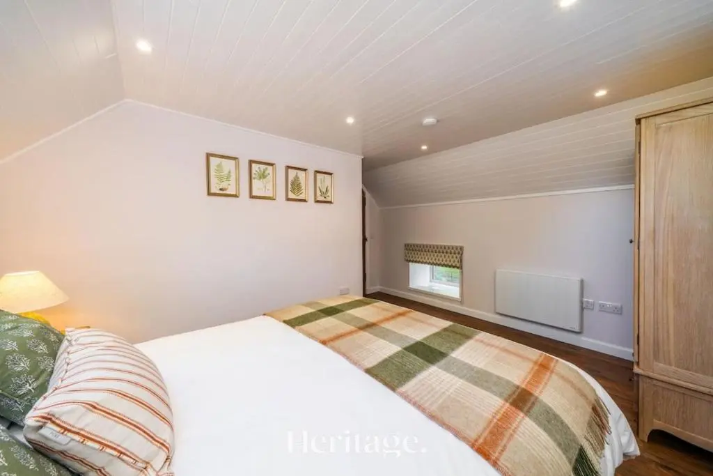 a bedroom with a bed in a room at The Byre, Countryside Home in Tough