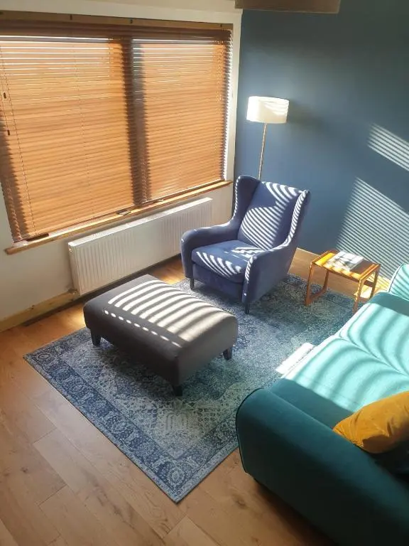 a living room with a couch and a chair at 1 Bed Apartment Inverness with City Views in Inverness