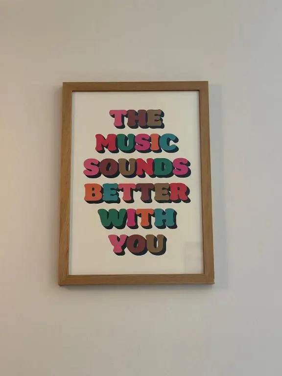 a framed picture of the music sounds better with you at Serendipity The Apartment in South Kessock