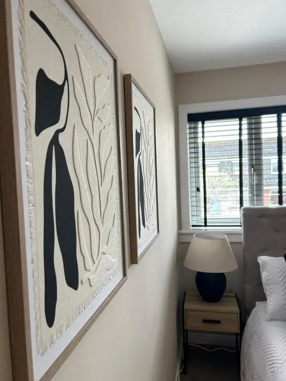a bedroom with two framed pictures on the wall at Newly refurbished 3 bed house in Inverness