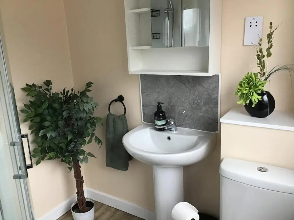 a bathroom with a white sink and a toilet at Newly refurbished 3 bed house in Inverness