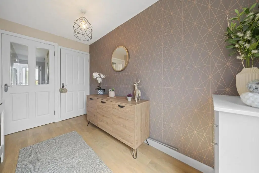 a bathroom with a tiled wall with a wooden dresser at Heather 3 Bedroom House - Inverness in Inverness