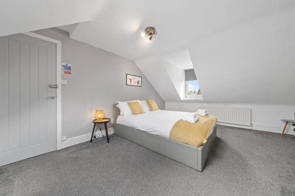 a white bedroom with a bed and a table at Crown 3 Bedroom Apartment - Inverness in Inverness