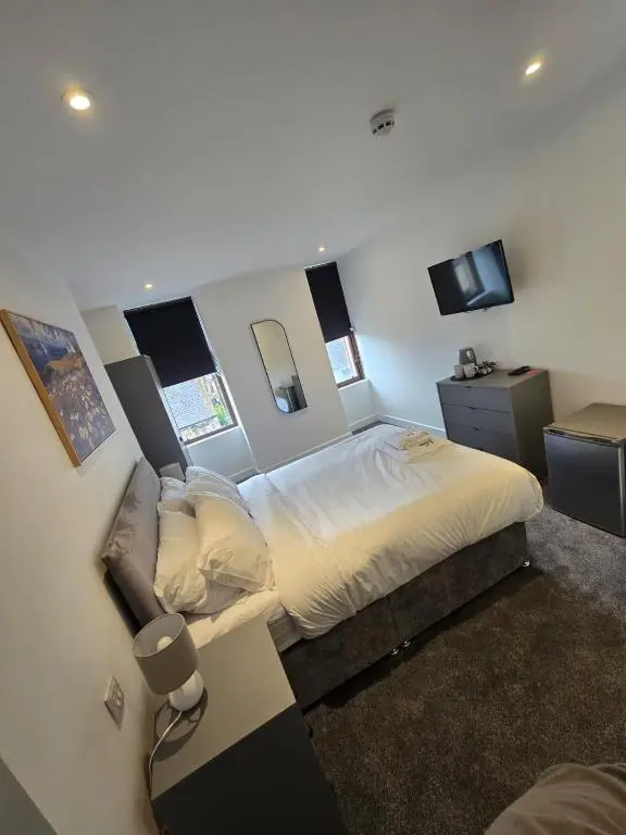 a bedroom with a large bed and a television at Taigh Mor in Elgin