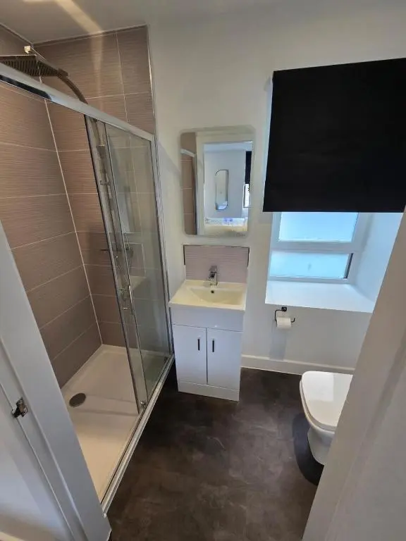 a bathroom with a shower and a toilet and a sink at Taigh Mor in Elgin