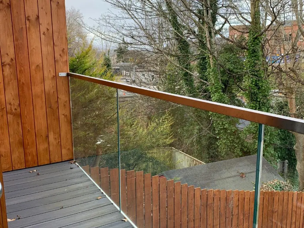 a balcony with a glass railing on a house at View Apartment in Inverness