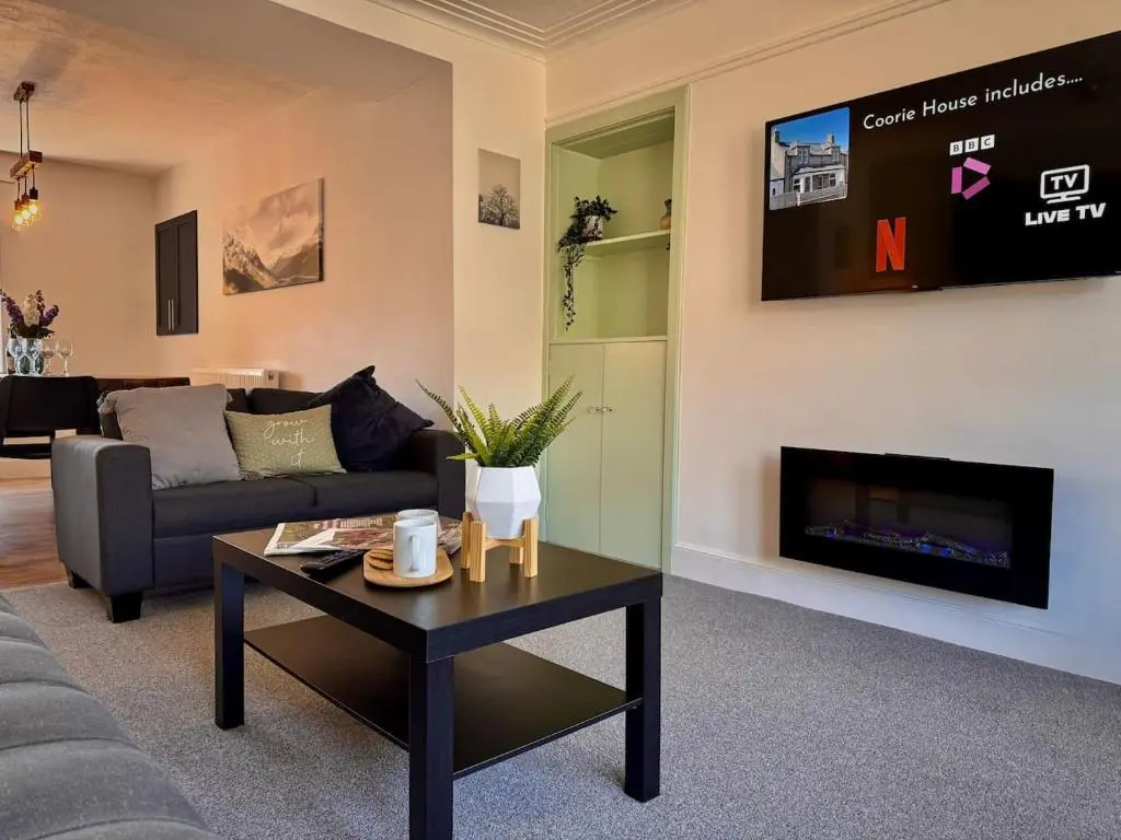 a living room with a couch and a tv at Coorie House in Elgin in Elgin
