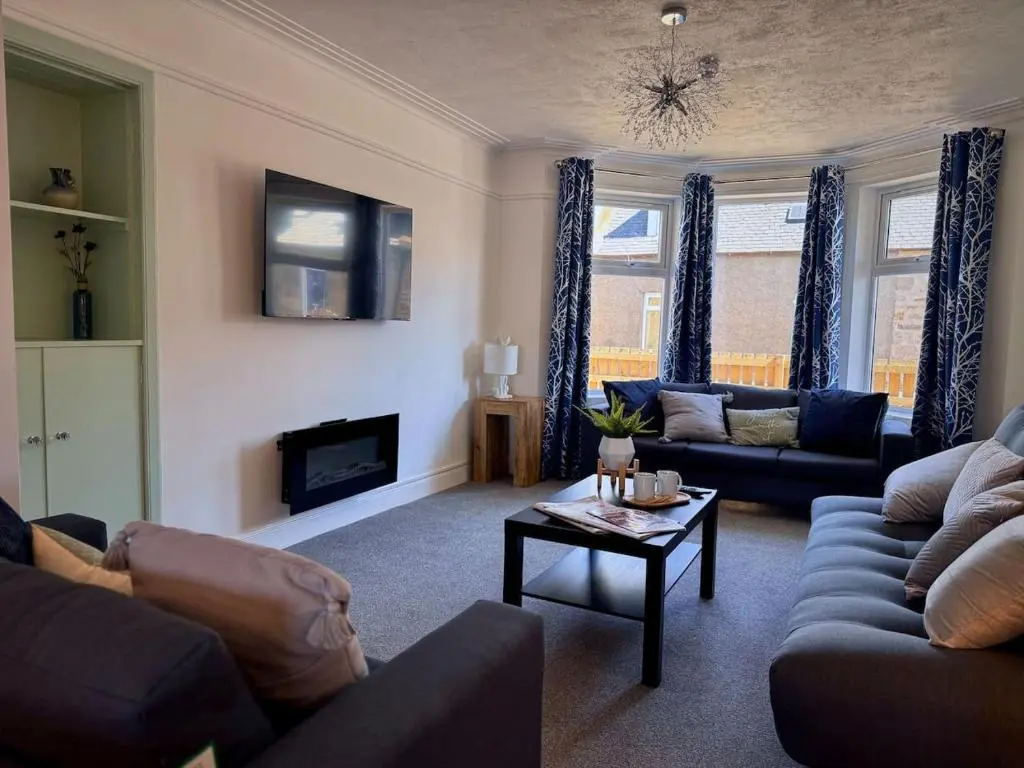 a living room with couches and a coffee table at Coorie House in Elgin in Elgin