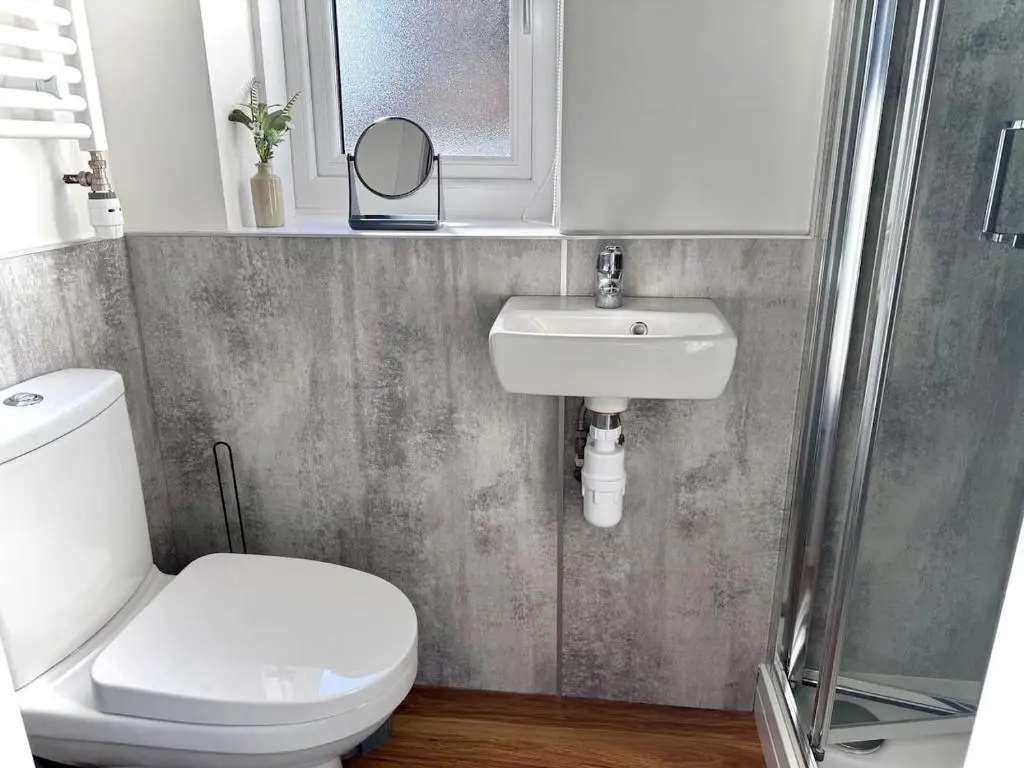 a bathroom with a toilet and a sink and a shower at Coorie House in Elgin in Elgin