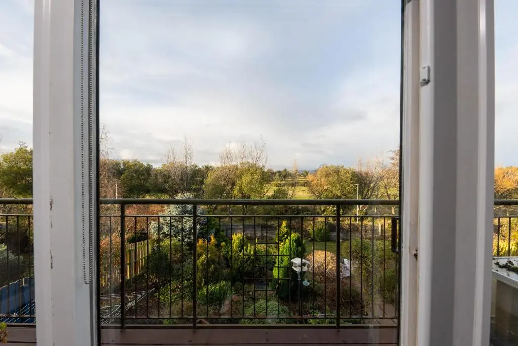 a window view of a garden from a balcony at Lochnomore - A Luxury Home With Magnificent Views in Nairn