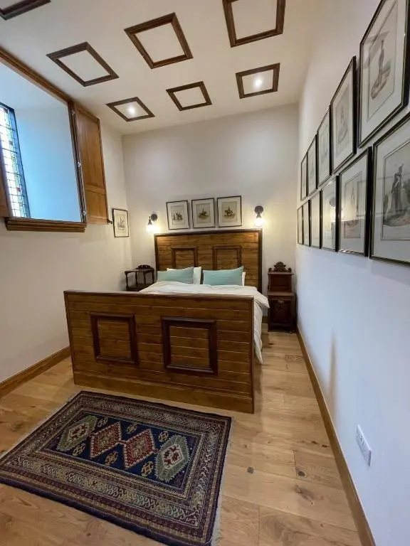 a bedroom with a large bed and a rug at Church Brae in Tomatin
