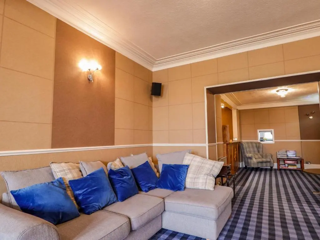 a living room with a couch with blue pillows at Crannoch Self Catering in Buckie