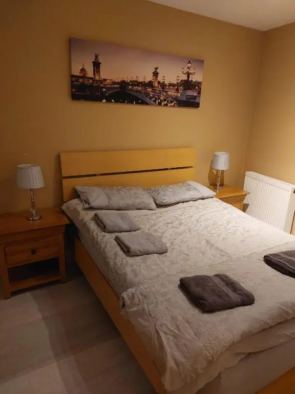 a bedroom with a large bed with two night stands at Church Street Apartments in Inverness