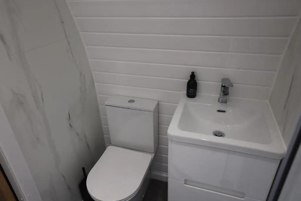 a small bathroom with a toilet and a sink at Lochend Pods - Deas Pod in Inverlael
