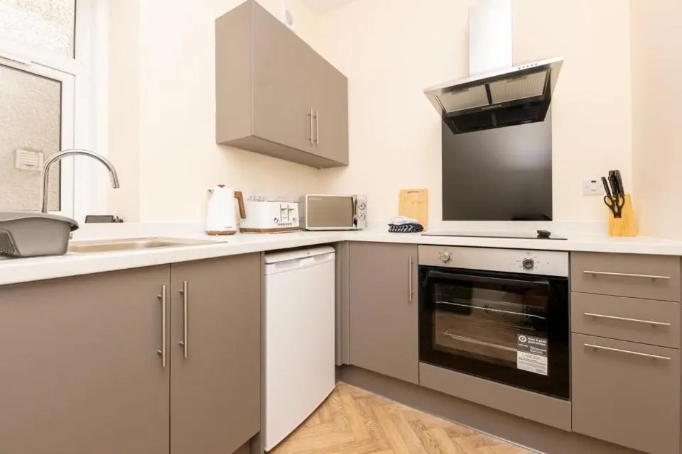 a kitchen with a sink and a stove top oven at 1 BDR Apt By Caledonia Luxe Stays Short Lets & Serviced Accommodation Inverness in Inverness