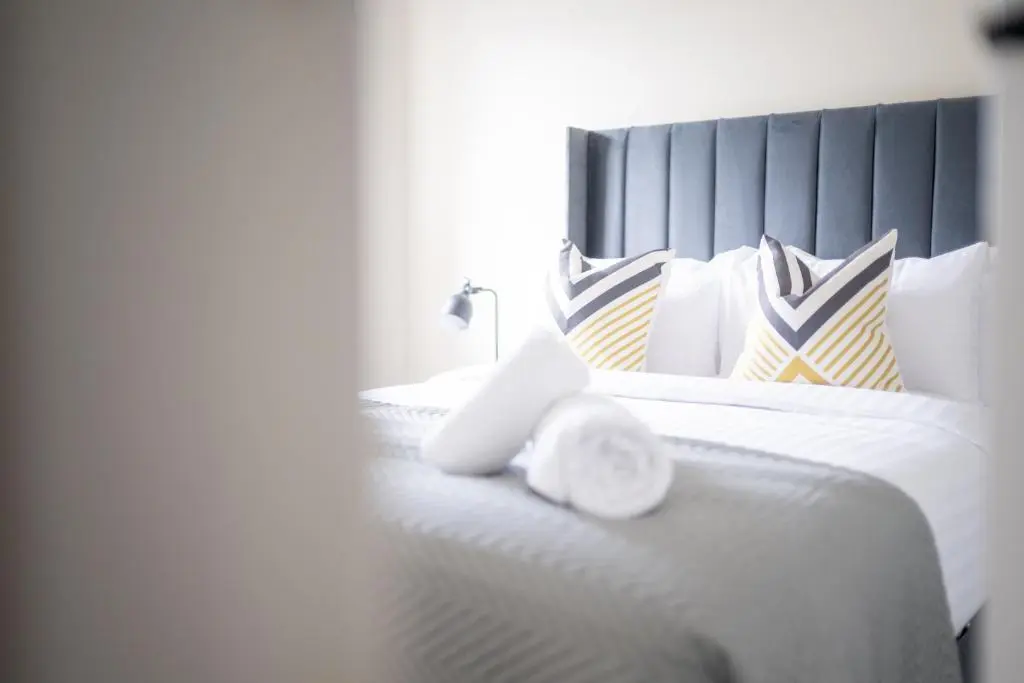 a bedroom with a large white bed with pillows at 1 BDR Flat At Caledonia Luxe Stays Short Lets & Serviced Accommodation Inverness in Inverness