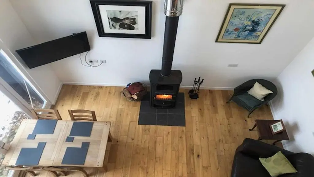 an overhead view of a living room with a wood stove at Coach House in Drumnadrochit