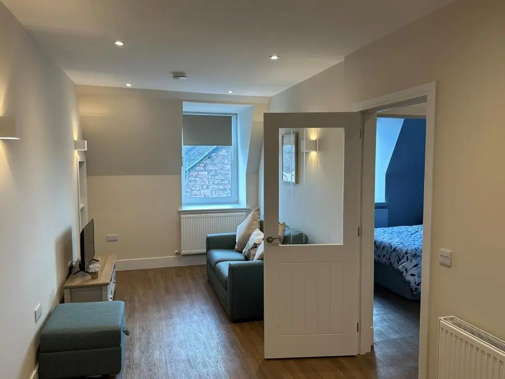a living room with a couch and a bed at Highland Home on the Hill in Inverness