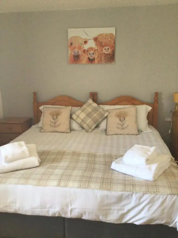 a large bed with two pillows on top of it at The Castle Hotel NR TAIN in Portmahomack