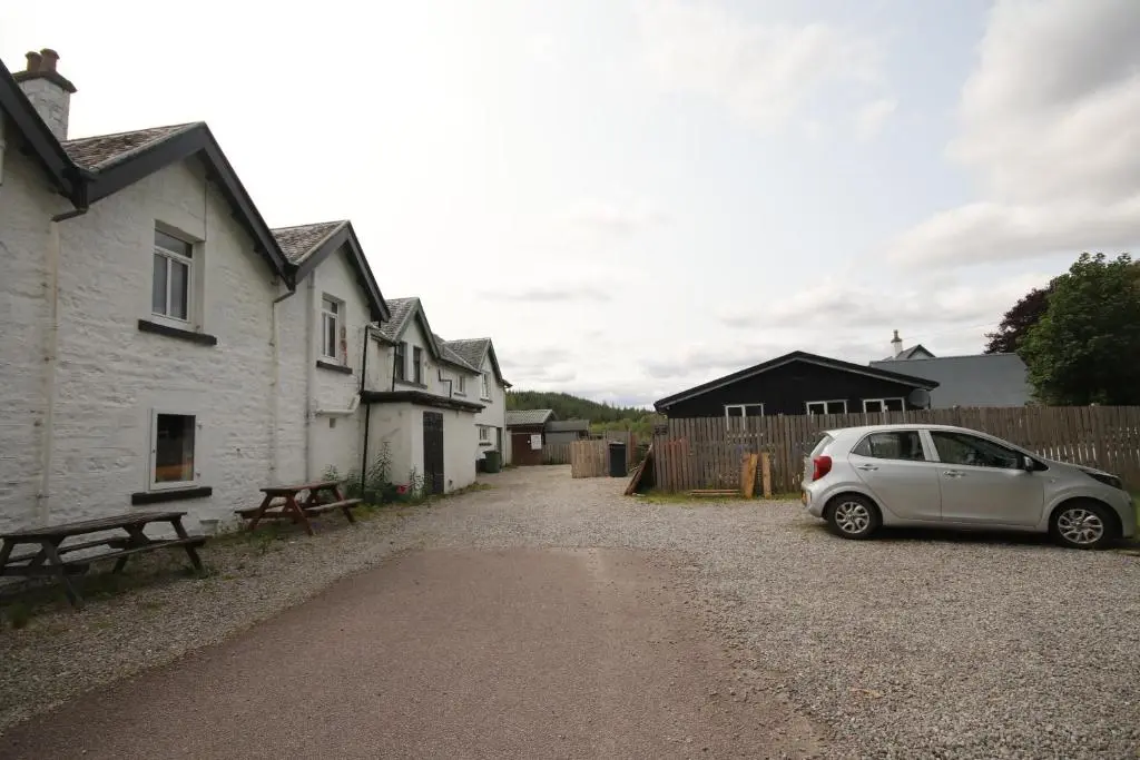 a white car parked in front of a house at Owl View in Garve