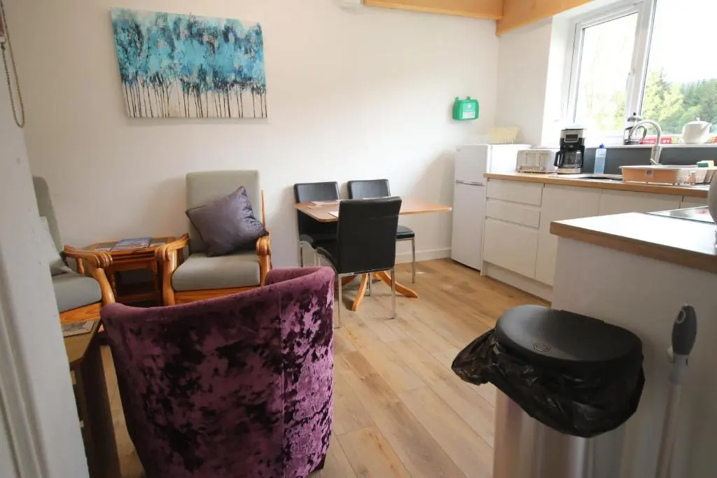 a kitchen with chairs and a table in a room at Owl View in Garve
