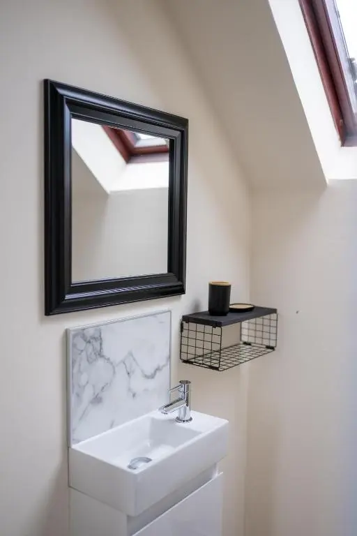 a bathroom with a sink and a mirror at 2 BDR Apt At Caledonia Luxe Stays Short Lets & Serviced Accommodation Inverness in Inverness