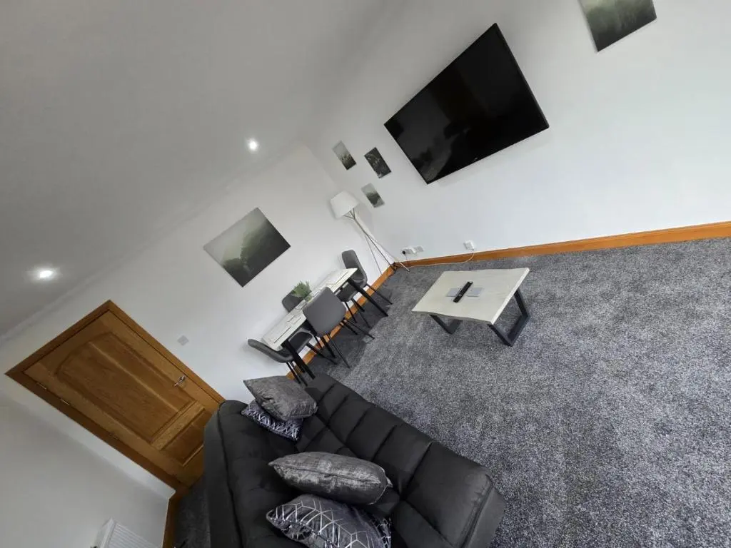 an overhead view of a living room with a couch and a tv at Forres Nights in Forres