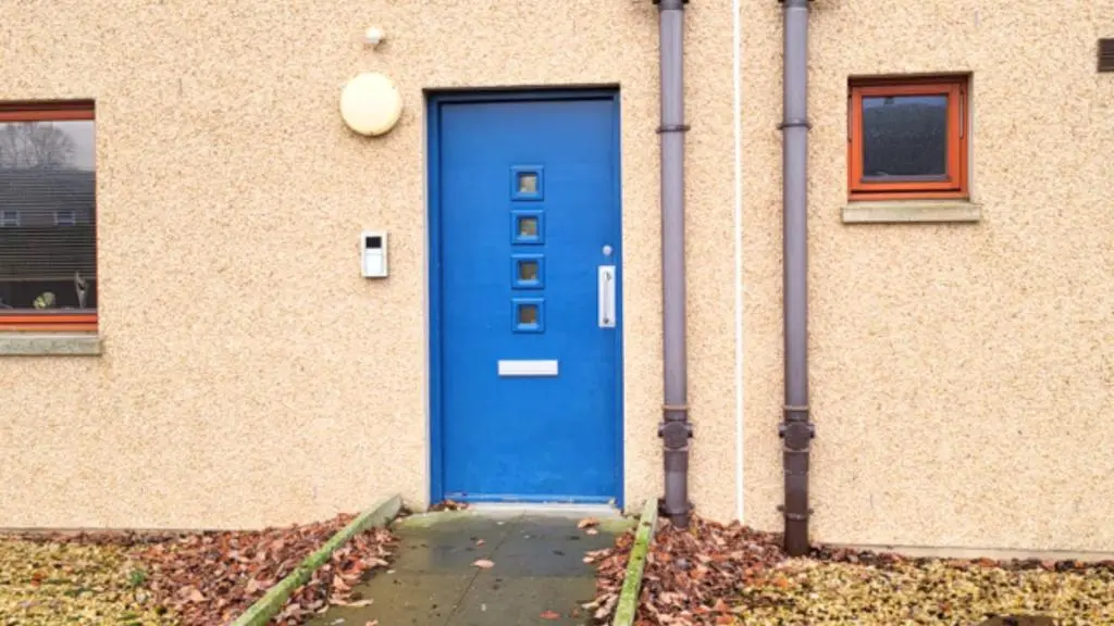 a blue door on the side of a building at Forres Nights in Forres