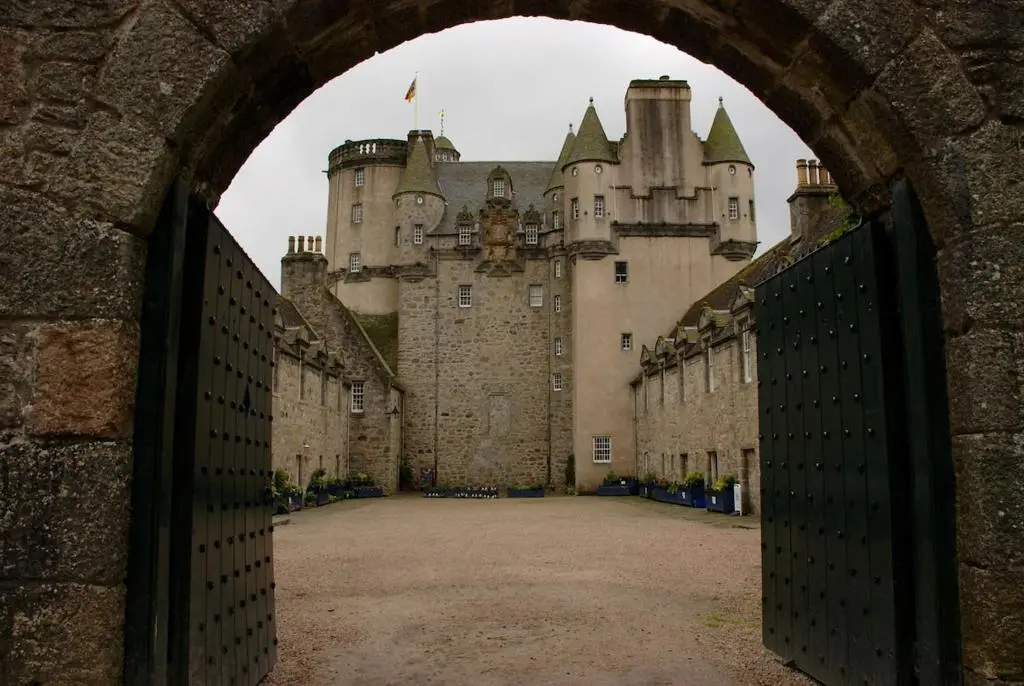 an entrance to a castle with a gate in front at Bright and cosy central flat in Inverurie in Inverurie