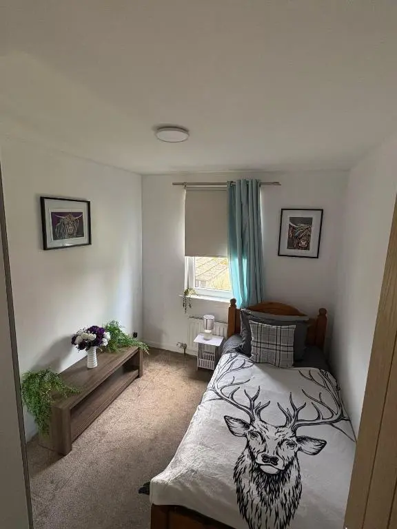 a bedroom with a bed with a drawing of a deer on it at Cloverdale Aparthotel in Aberdeen